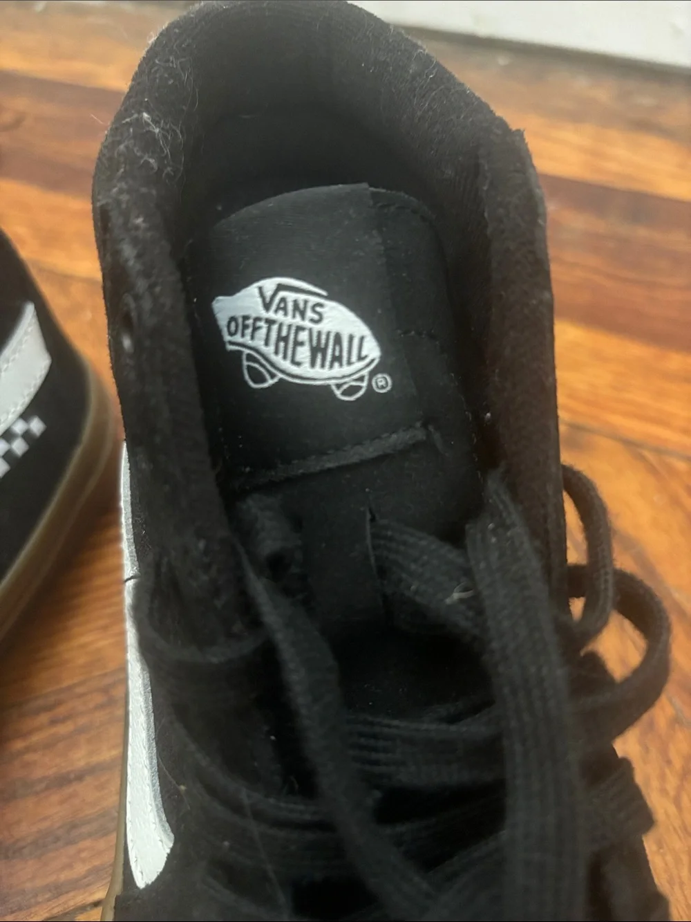 Black canvas vans hightops with brown rubber soles and white logo+ racing detail